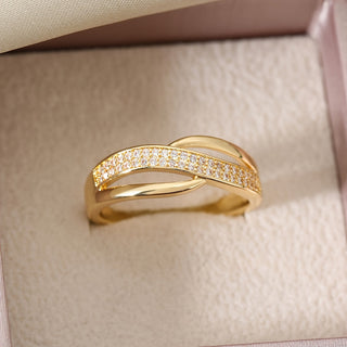 Elegant gold crossover ring adorned with stones