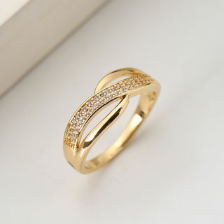 Elegant gold crossover ring adorned with stones