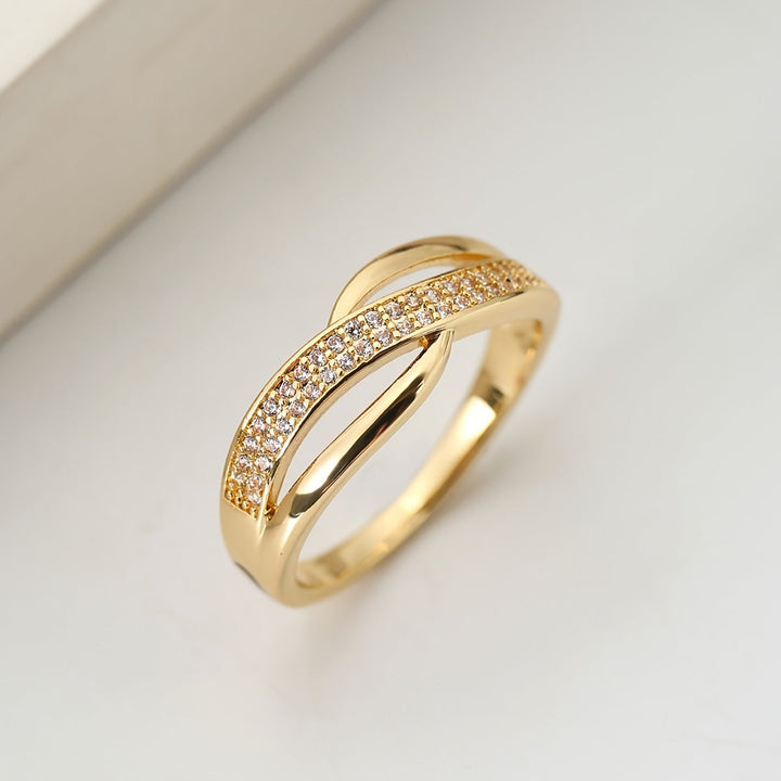 Elegant gold crossover ring adorned with stones