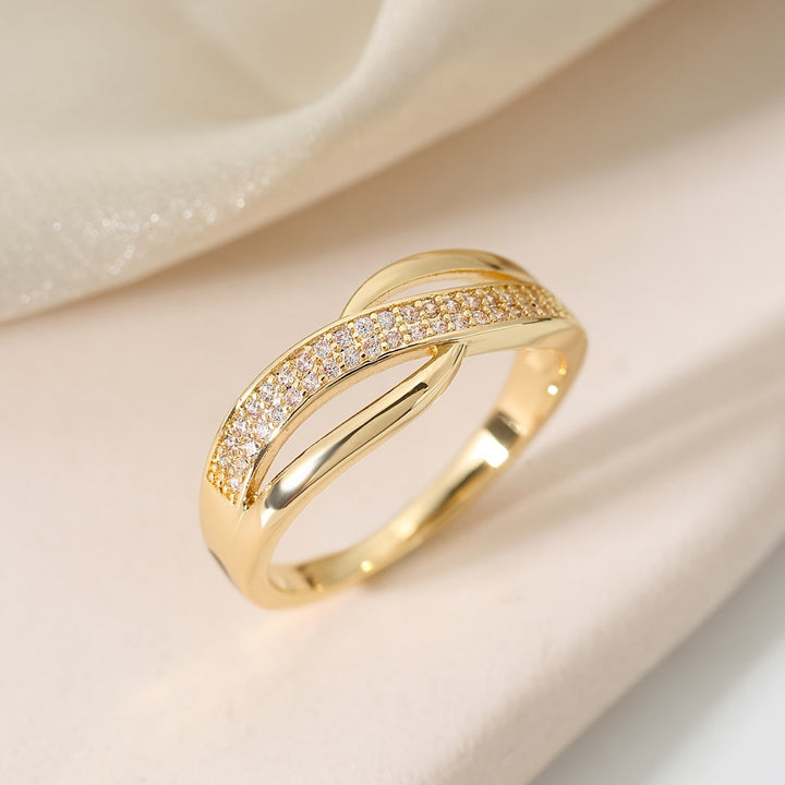 Elegant gold crossover ring adorned with stones