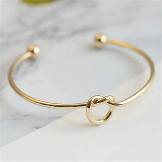 Gold bracelet with knot detail